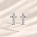 Philologi 15mm cross moissanite earrings on warm ivory silk