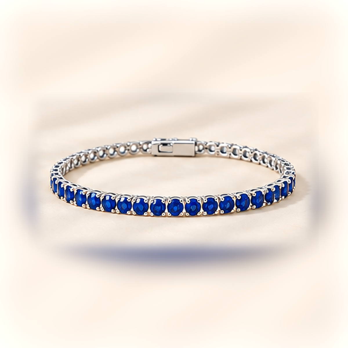3mm lab-grown sapphire tennis bracelet in 925 sterling silver on warm ivory background