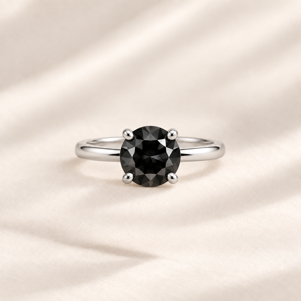Philologi black moissanite ring on warm ivory silk