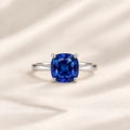 Philologi cushion cut lab blue corundum ring on warm ivory silk