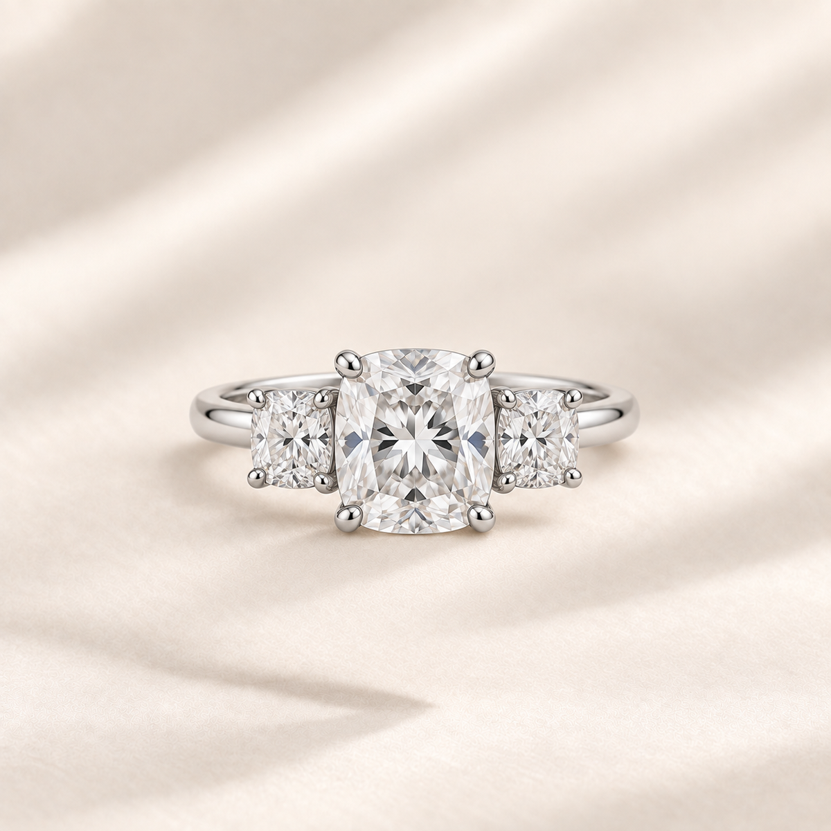 Philologi cushion moissanite three-stone ring with 2ct centre on warm ivory silk