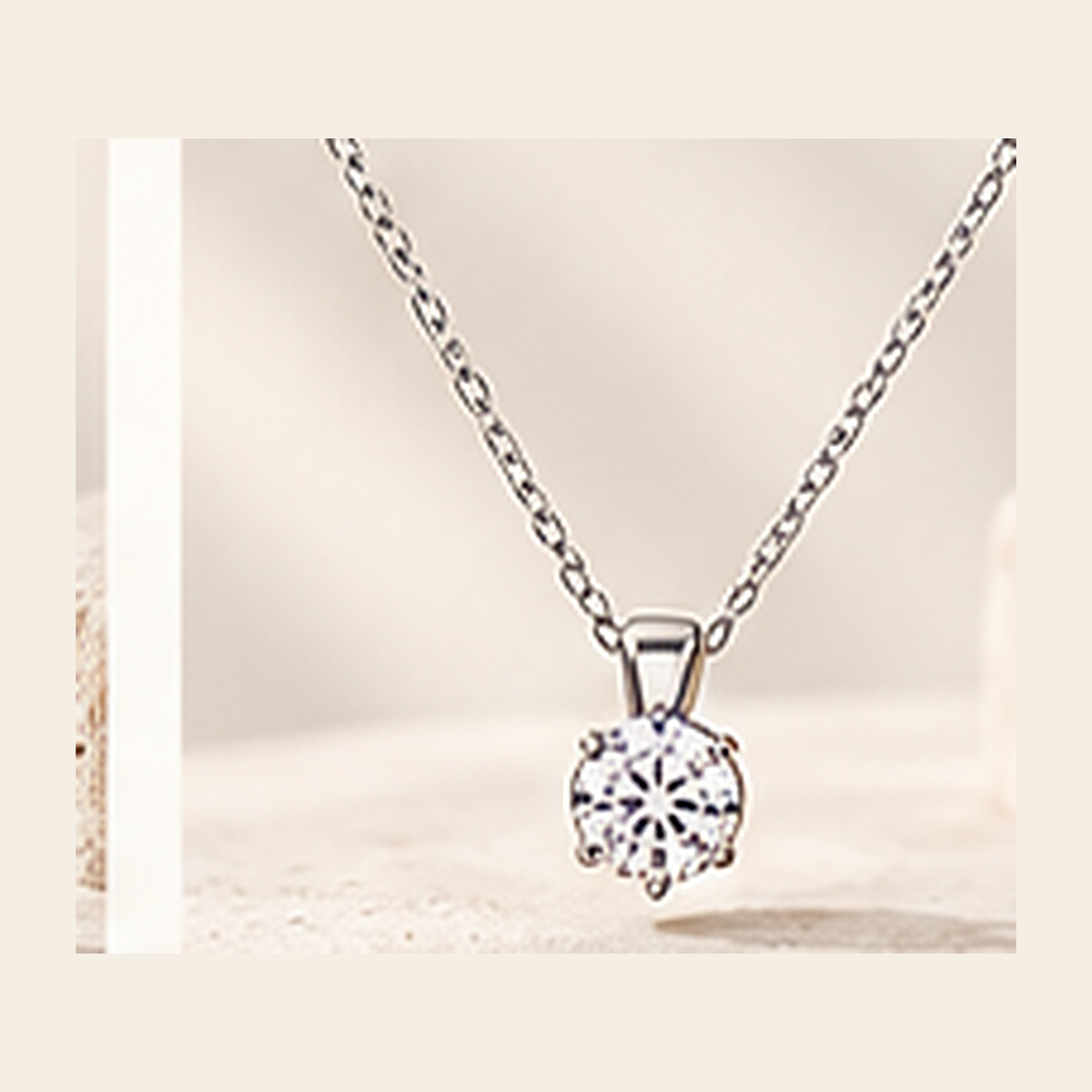 Philologi D color moissanite solitaire necklace on warm ivory silk