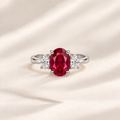 Philologi oval lab ruby three-stone ring on warm ivory silk