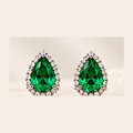 Philologi pear moissanite stud earrings on warm ivory silk