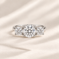 Philologi round moissanite three-stone ring with 2ct centre and 1ct side stones on warm ivory silk