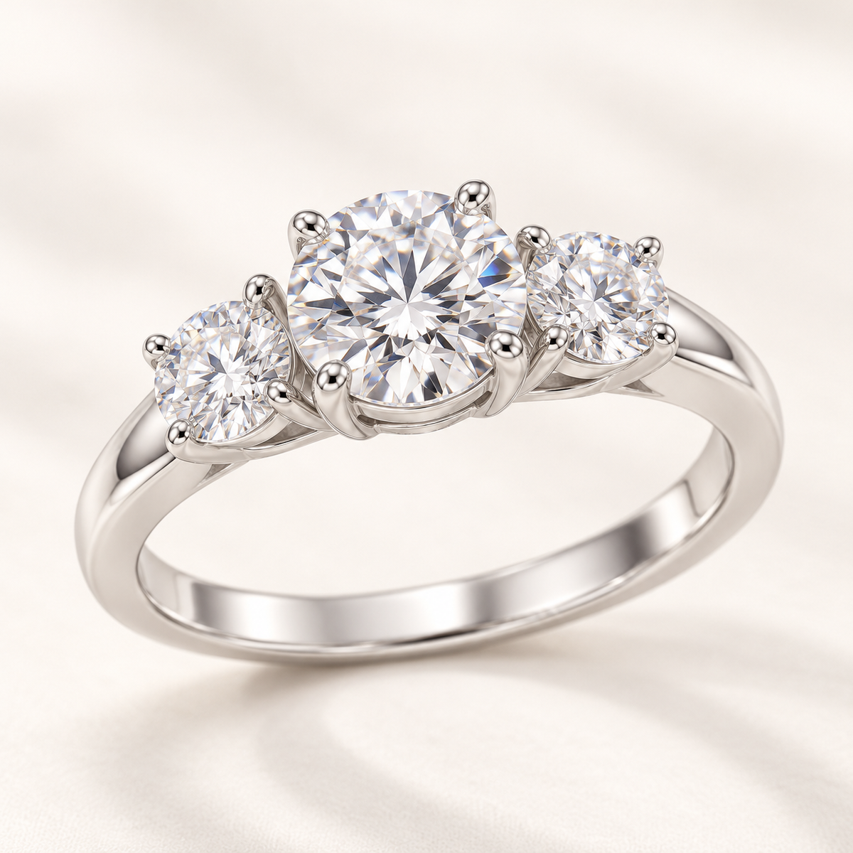 Round moissanite three-stone ring in 925 sterling silver, angled view